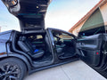 Tesla Model X falcon wing doors open with teal TslaModz ambient lighting