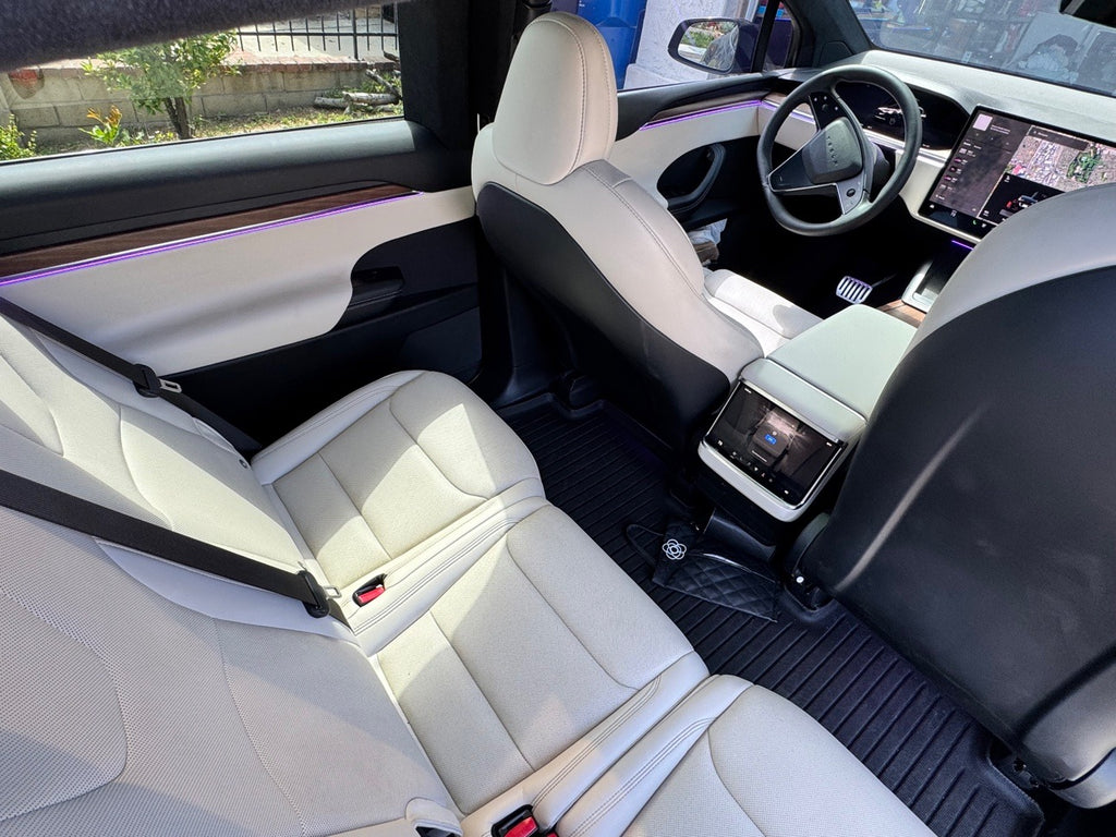Tesla Model X rear seats, white interior, with purple door ambient lighting